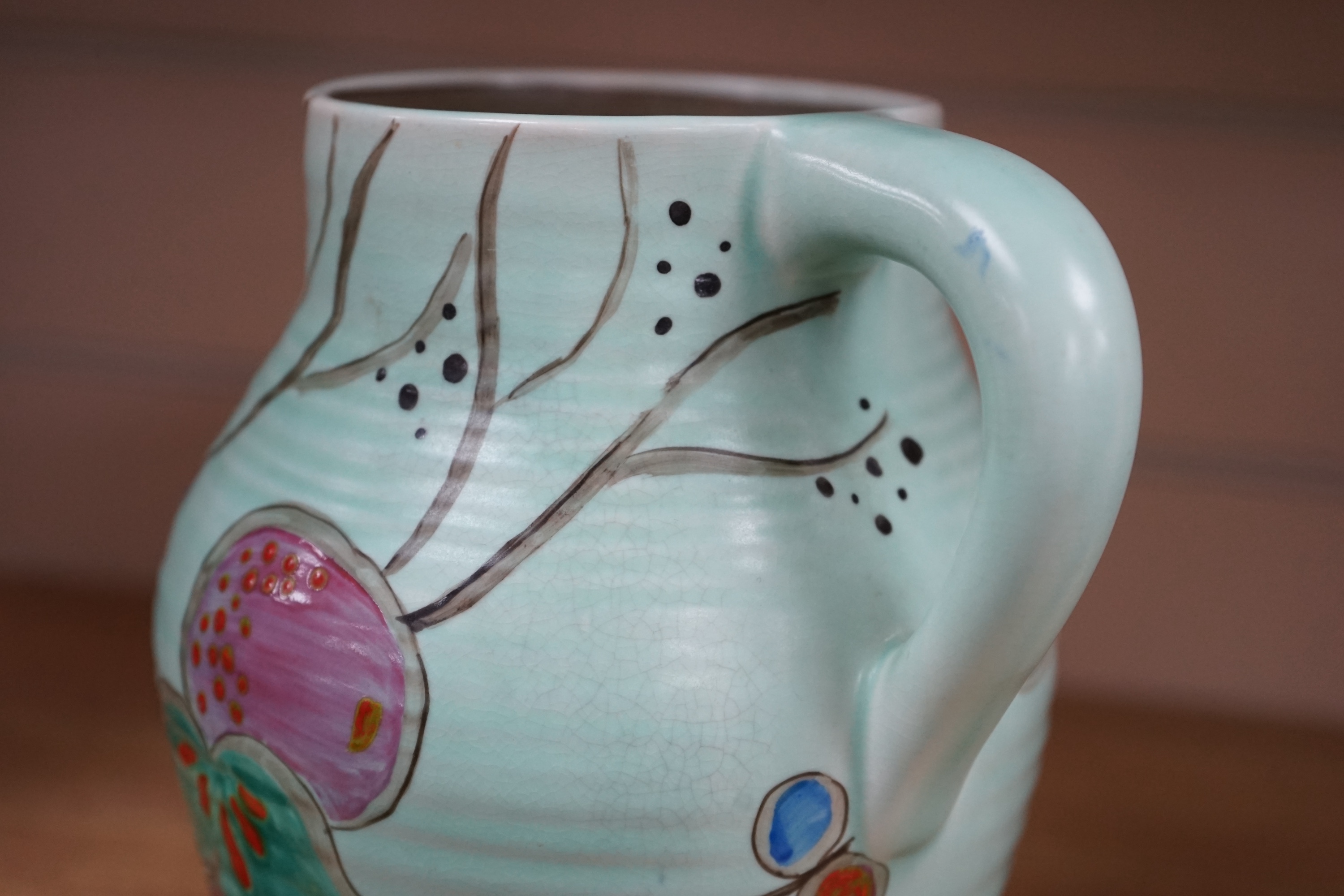 A Clarice Cliff ‘passion fruit’ decorated small lotus jug, 19.5cm. Condition - good